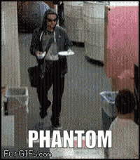 a man walking down a hallway with the word phantom on the bottom right