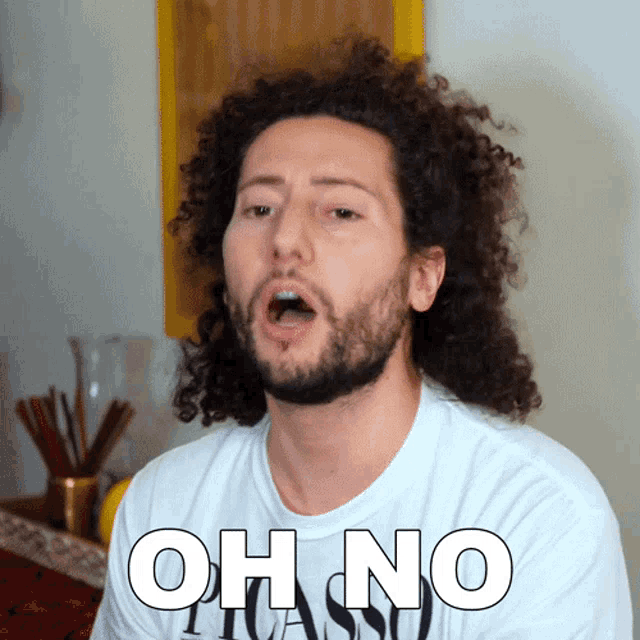 a man with curly hair is wearing a shirt that says oh no picasso