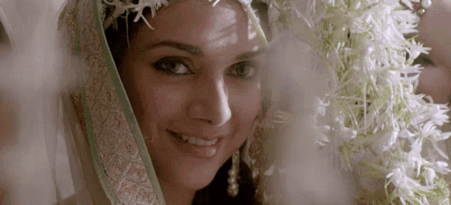a woman wearing a veil and flowers on her head