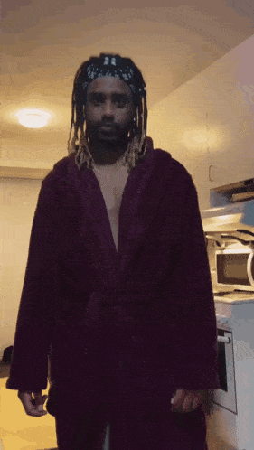 a man wearing a purple robe and a bandana on his head