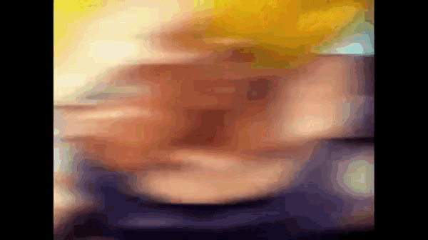 a blurry picture of a person 's face with a yellow headband .