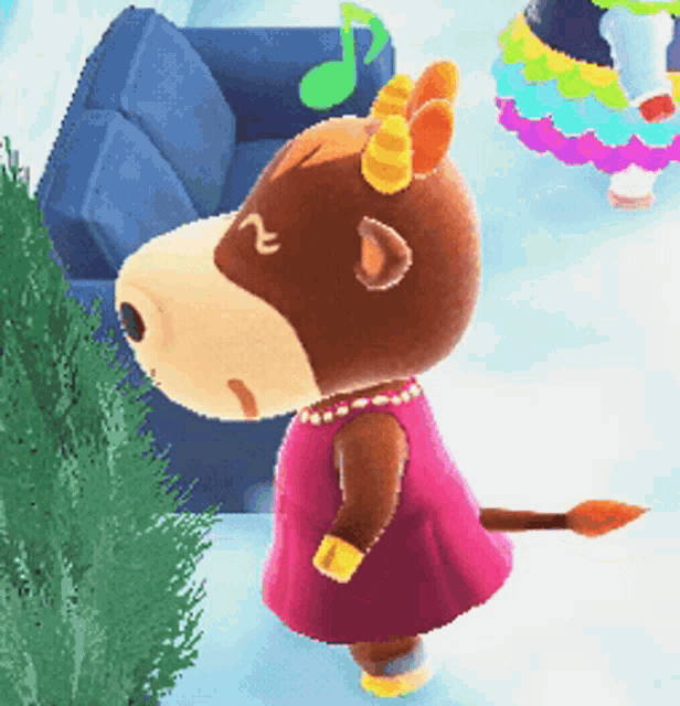 a cow wearing a pink dress and horns is standing in front of a blue couch