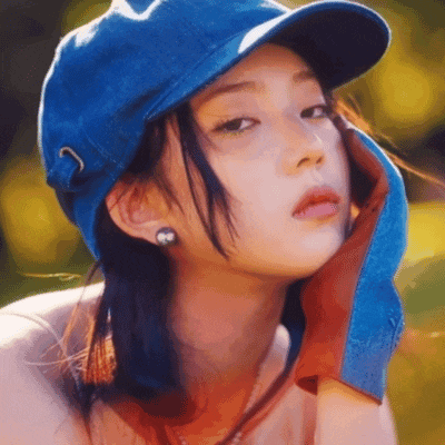 a girl wearing a blue hat and a red glove