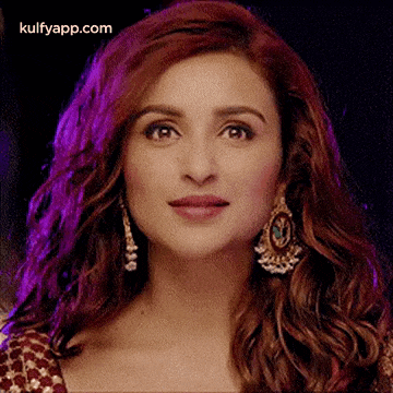 a close up of a woman 's face with a purple background .