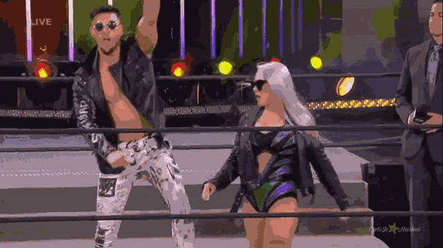 a man and a woman are in a wrestling ring with the word live on the bottom left