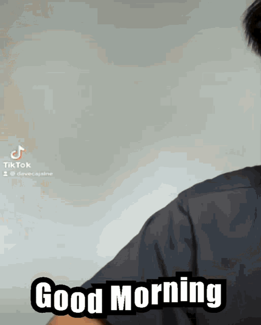 a man in a black shirt says good morning on a tiktok video