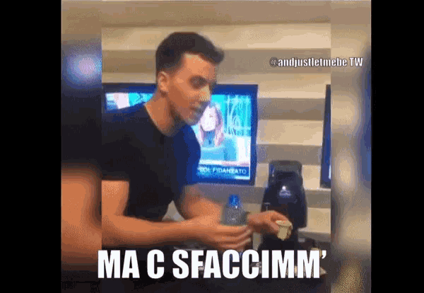 a man in a black shirt is holding a bottle and a cup with the caption ma c sfaccimm '