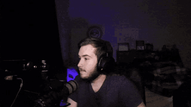 a man wearing headphones is sitting in front of a computer monitor