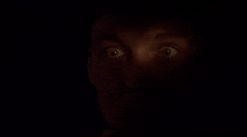 a close up of a person 's eyes in the dark .