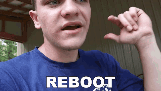 a man in a blue shirt with the word reboot on it