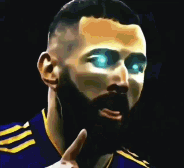 a man with a beard and blue eyes is wearing a blue and yellow shirt