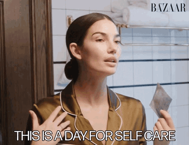 a woman holding a piece of paper with the words this is a day for self care