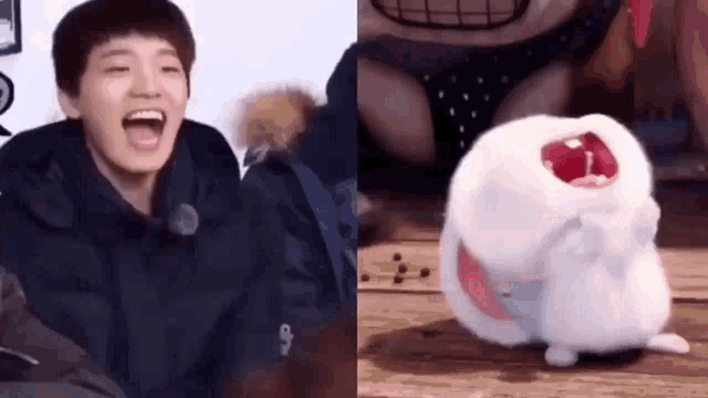 a man is laughing next to a stuffed animal with a hole in its mouth .