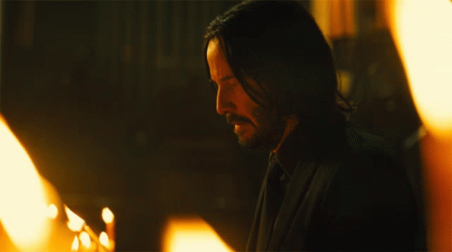 Blowing Out Candle John Wick GIF - Blowing Out Candle John Wick Keanu Reeves GIFs