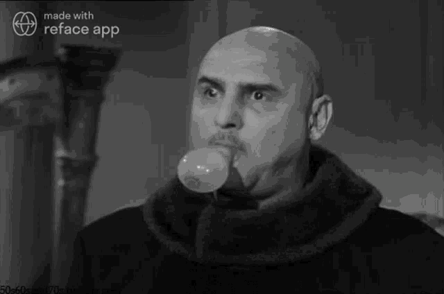 a bald man blowing a bubble gum in a black and white photo