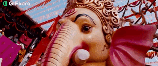 a close up of a statue of a deity with a crown on his head .