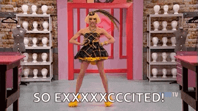 a drag queen is dancing in a room with mannequins and a sign that says `` so exxxxcccited ! ''