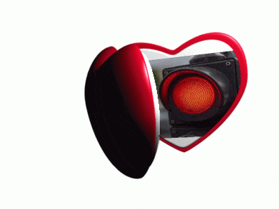 a heart shaped mirror shows a red light on a white background
