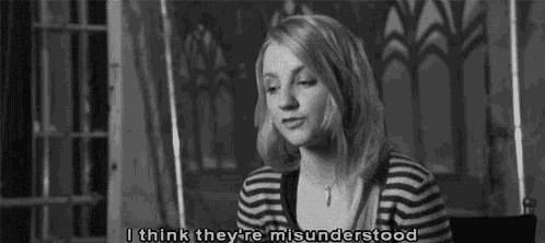 a black and white photo of a woman in a striped shirt saying `` i think they are misunderstood '' .