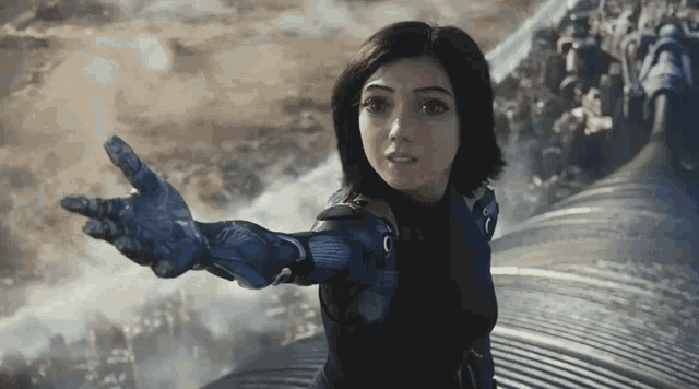 a woman with a robotic arm is standing in front of a city