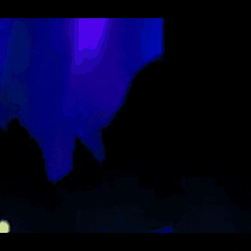 a silhouette of a monster with glowing eyes is floating in the dark .