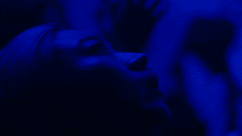 a close up of a person 's face with blue background