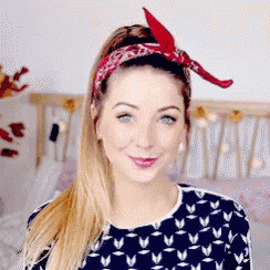a woman wearing a bandana in her hair is smiling .