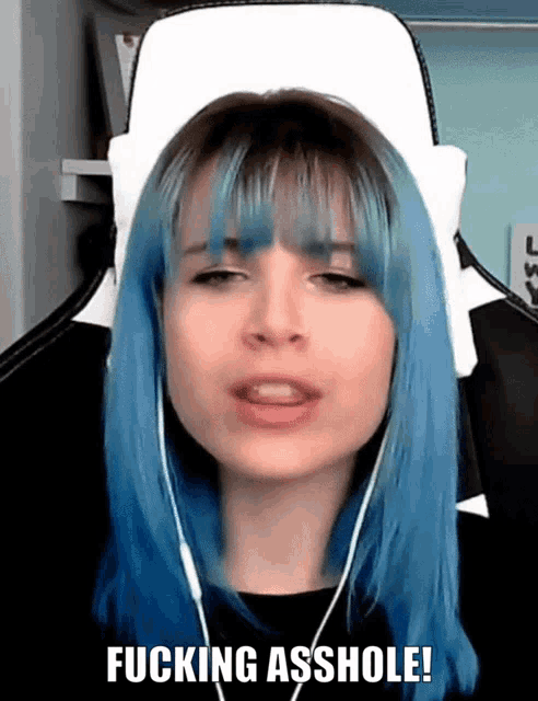 a woman with blue hair says fucking asshole in a video