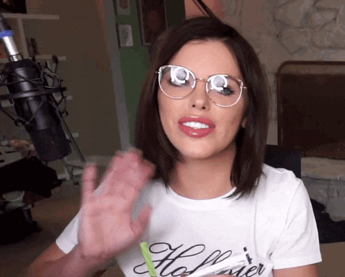 a woman wearing glasses and a t-shirt that says the power
