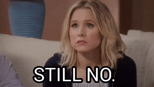 a woman is sitting on a couch with a sign that says still no .