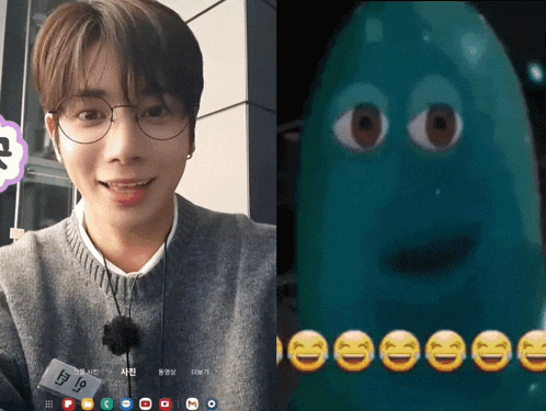 a man wearing glasses is next to a picture of a green monster with smiley faces on it