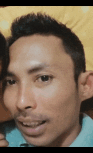 a close up of a man 's face with a blurred background