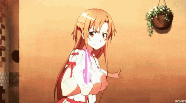 a girl with long hair is standing in front of a wall and giving a thumbs up sign .