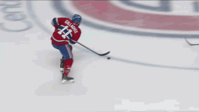 a hockey player with the number 11 on his jersey is skating on the ice