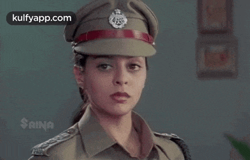 a woman is wearing a police uniform and hat .