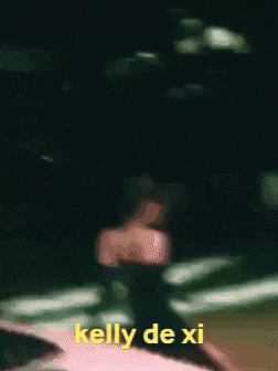 a blurry picture of a person with kelly de xi written on the bottom