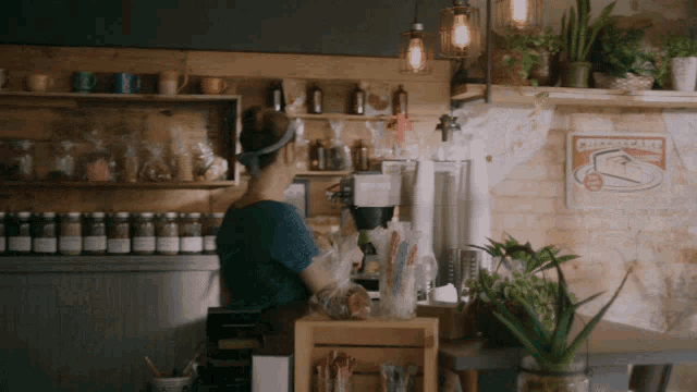 a woman behind a counter with a sign that says cheesecake on it