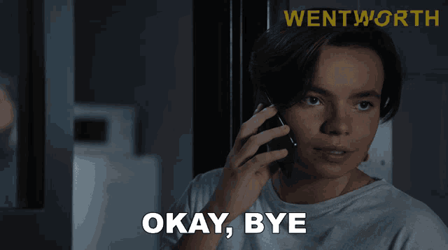 a woman says okay bye while holding a cell phone