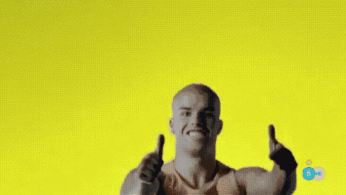 a bald man is giving a thumbs up sign while wearing a red tank top .