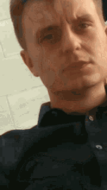 a close up of a man 's face with his eyes closed