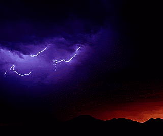 lightning strikes in a purple sky with a mountain in the background