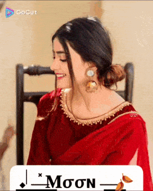 a woman wearing a red dress and gold earrings is smiling in front of a gocut logo