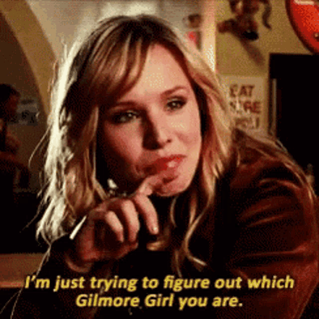 a woman is smoking a cigarette and saying i 'm just trying to figure out which gilmore girl you are