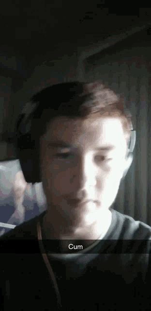 a young man wearing headphones with a caption that says cum on it