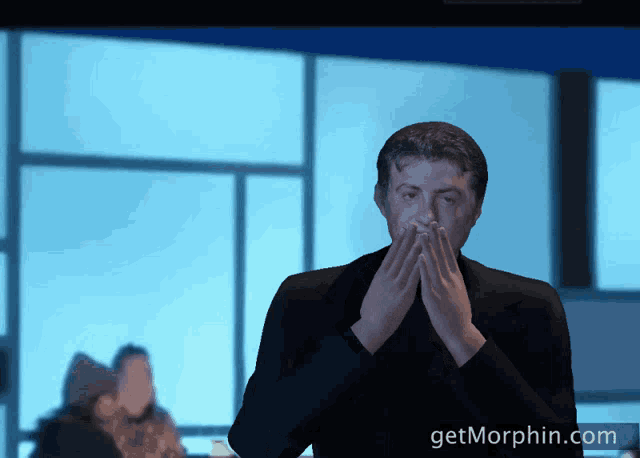 a man covering his mouth with his hands and the website getmorphin.com is displayed in the background