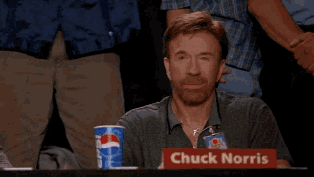 chuck norris is giving a thumbs up in front of a pepsi cup