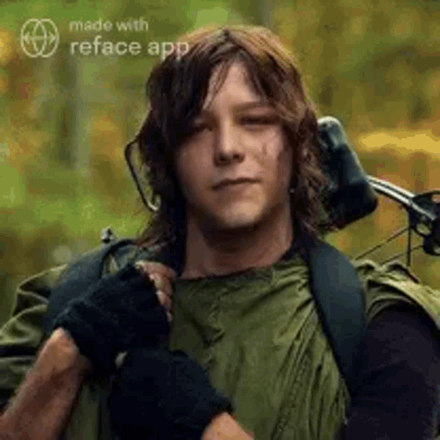 a man in a green jacket is holding a bow and arrow on his back .