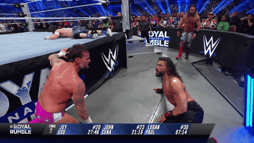 two wrestlers in a wrestling ring with the words royal rumble behind them