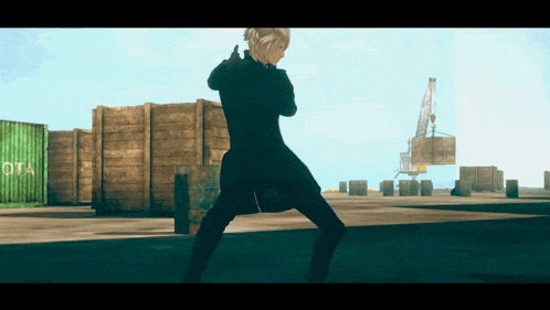 a man in a black coat is standing in front of a green container that says ota