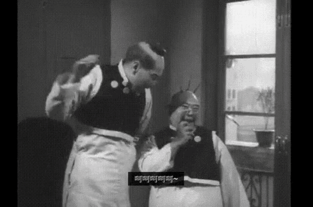 a black and white photo of two men with chinese writing on the bottom